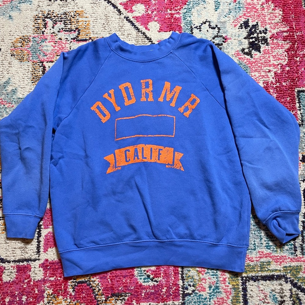 Daydreamer sweatshirt, vintage worn look, blue and orange design.